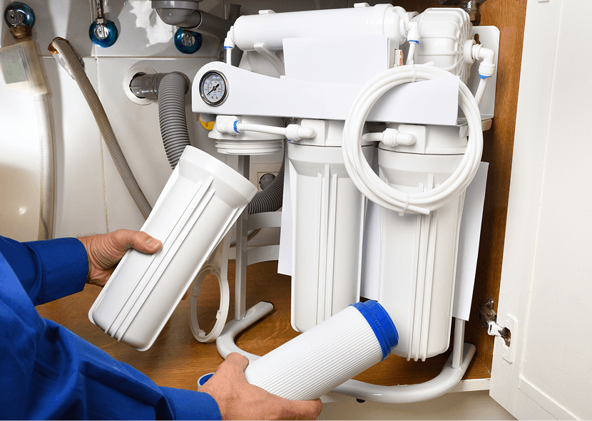 Hands holding water filter cartridges