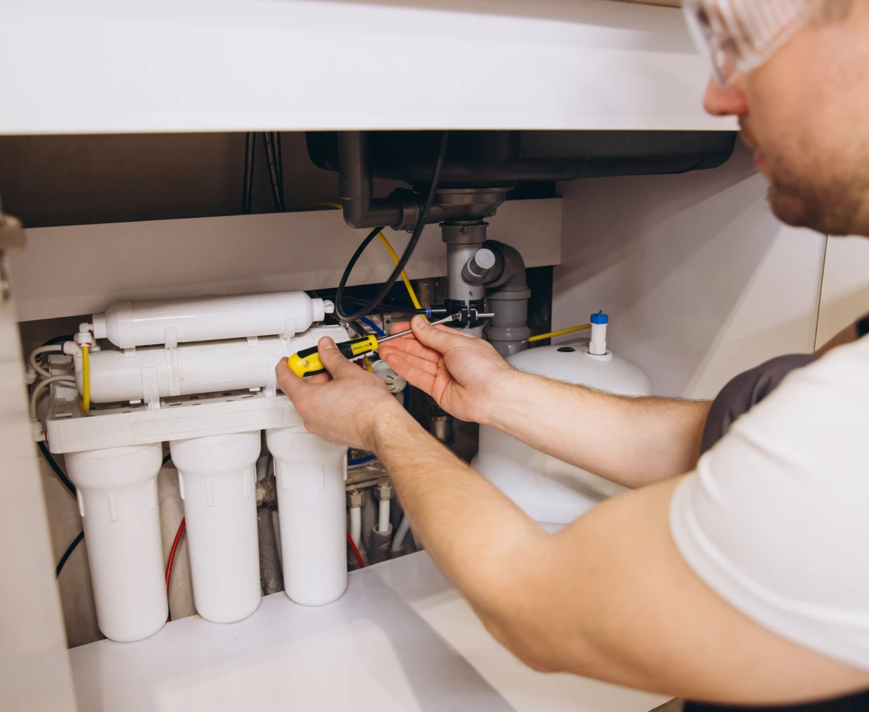 Person maintaining domestic water purification setup