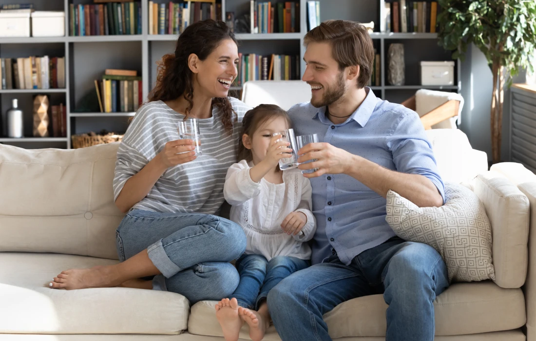 Family enjoying drinks on the couch